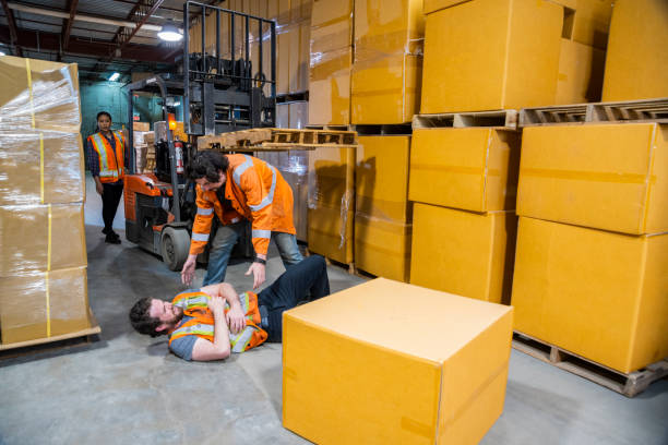 istock An industrial warehouse workplace safety topic. A worker injured falling or being struck by a forklift. 1163433254