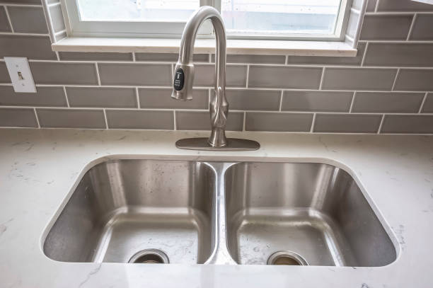istock Double bowl stainless steel sink undermounted on the white kitchen countertop 1163434731