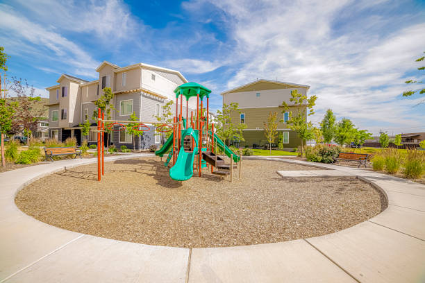 istock Playground surrounded by a circular pathway and benches under cloudy blue sky 1163435000