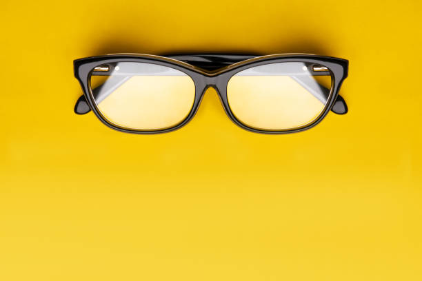 istock Glasses with transparent lenses isolated on yellow background. Front view with copy space. 1163435680