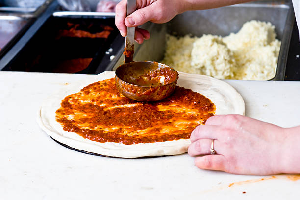 istock Tomato Sauce Topping on a Pizza 116343988