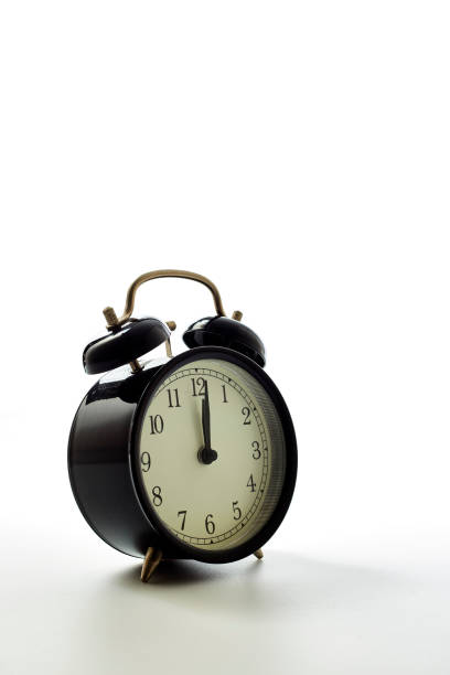 istock Black alarm clock retro style on white background. pointer in 12 o'clock. 1163448451