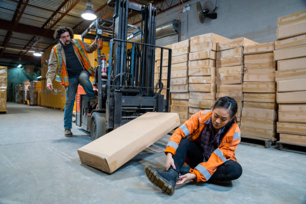 istock An industrial warehouse workplace safety topic. A worker injured falling or being struck by a forklift. 1163449016