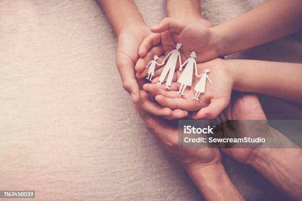 Adult And Children Hands Holding Paper Family Cutout Family Home Foster Care Homeless Support Concept Stock Photo - Download Image Now