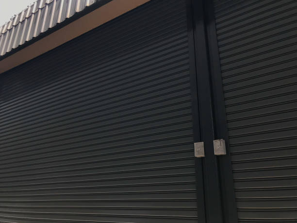 istock Steel warehouse door roll. Door open-close control switch 1163450420