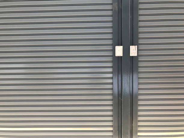 istock Steel warehouse door roll. Door open-close control switch 1163450431