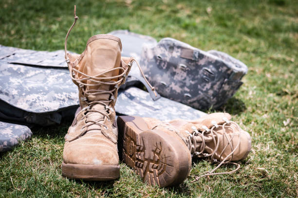 istock Military boots and helmet 1163453799