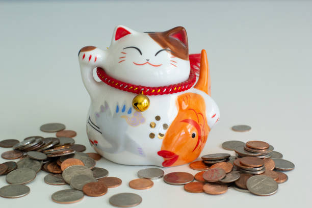 istock Cat shape Piggy bank with coins around 1163457011