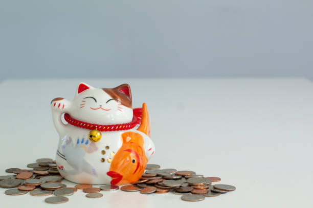 istock Cat shape Piggy bank with coins around 1163457017