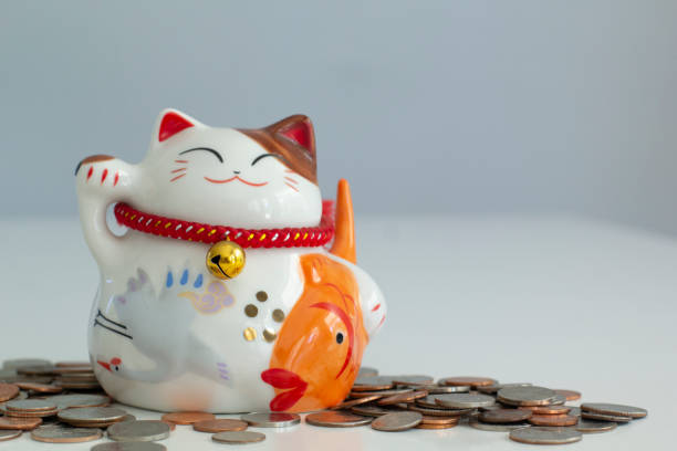 istock Cat shape Piggy bank with coins around 1163457838