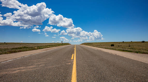 istock Long highway in the american desert, blue sky with clouds 1163458851