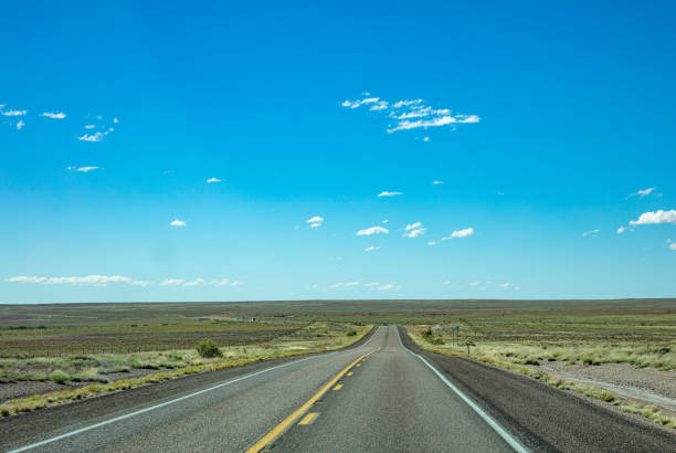 istock Long highway in the american desert, blue sky 1163458900