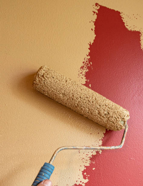 istock Paint roller painting brown over red - vertical 1163460667