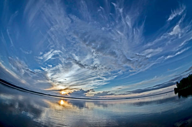 istock blue sunset sky with picturesque clouds is reflected in a calm lake 1163460886