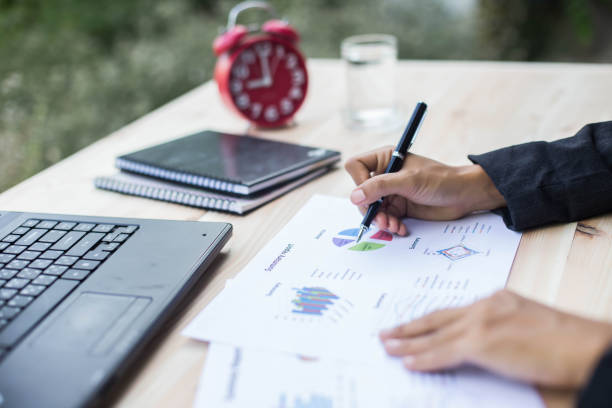 istock Modern workplace woman using mobile phone sitting at wooden table in office 1163465431