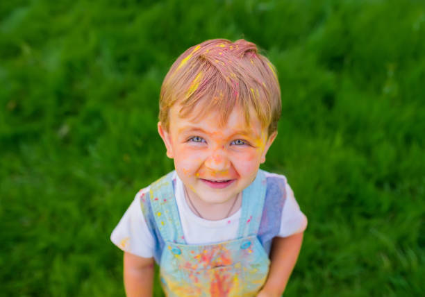 istock Laughing boy with paint stained his face. Top view 1163465701