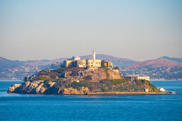 Famous Alcatraz Prison Island in San Francisco Bay, offshore from San Francisco, California Alcatraz Prison Island in San Francisco Bay, offshore from San Francisco, California, a small island with military fortification and federal prison, now a famous national historical landmark. alcatraz island photos stock pictures, royalty-free photos & images