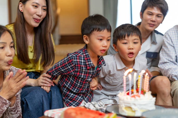 istock Young Boys Blowing Out Birthday Cake Candles 1163470307