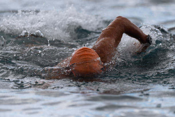 istock Man swimmer swimming crawl in blue sea 1163471283