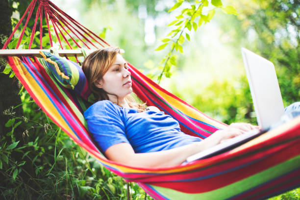 istock Young woman working remotely  from country house 1163471314
