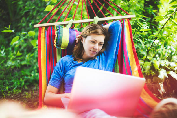 istock Young woman working remotely  from country house 1163471315