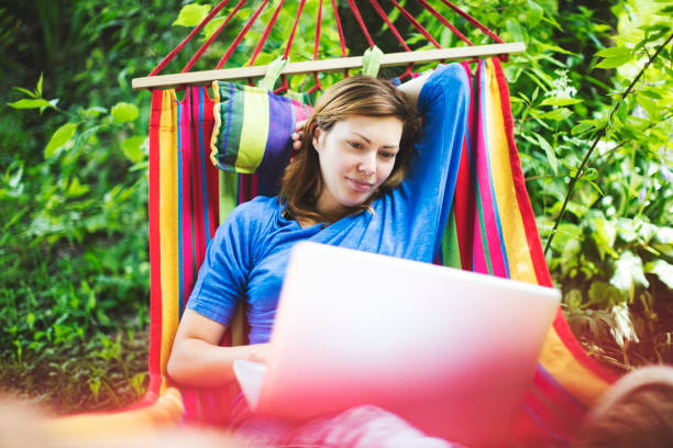 istock Young woman working remotely  from country house 1163471428