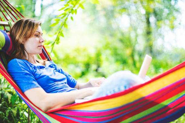 istock Young woman working remotely  from country house 1163472116