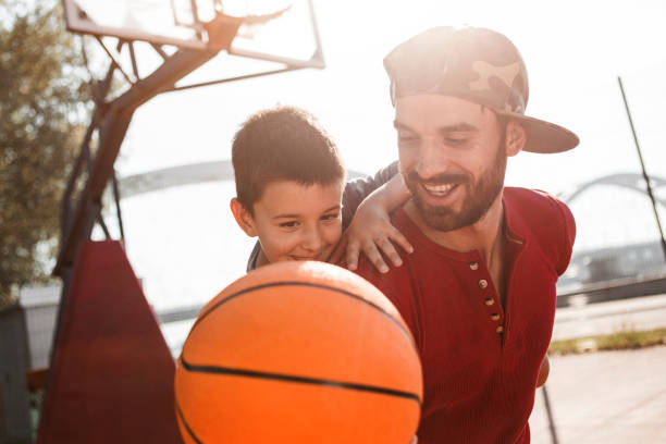 istock Father and sun having fun playing baketball 1163472449