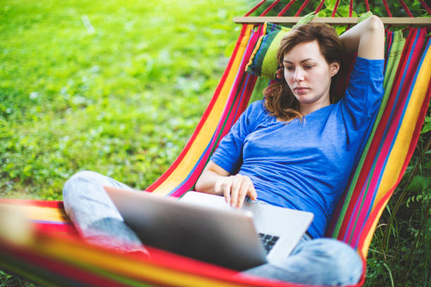 istock Young woman working remotely  from country house 1163472607