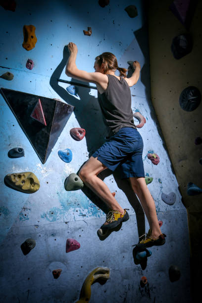 istock Teenage Boy Training Climbing On Indoor Climbing Wall 1163474531