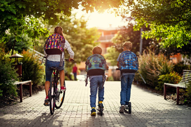 istock Kids riding bikes to school 1163475577