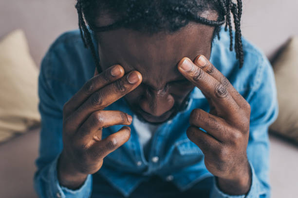 istock overhead view of african american man holding hands near head while suffering from headache 1163477005