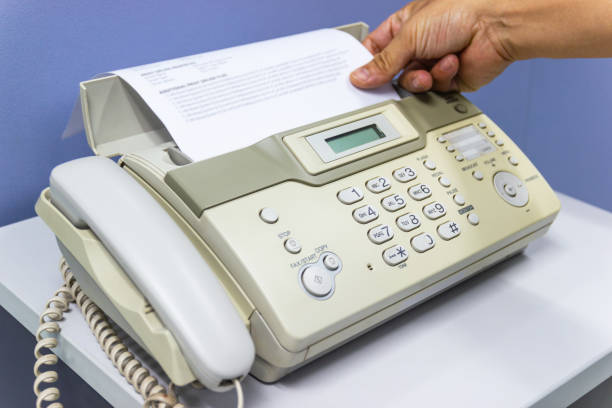 istock hand man are using a fax machine in the office, equipment for data transmission. 1163477374