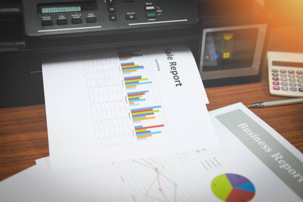 istock printer printing business reports sale and pile of documents report graph chart on a table office 1163479562