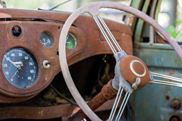 Close up of the interior of an old rusting vintage car left abandoned in the bush