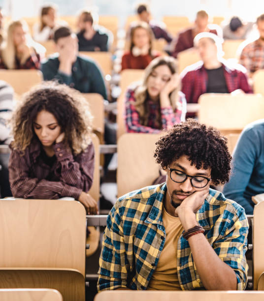 istock Large group of bored college students in a lecture hall. 1163481711