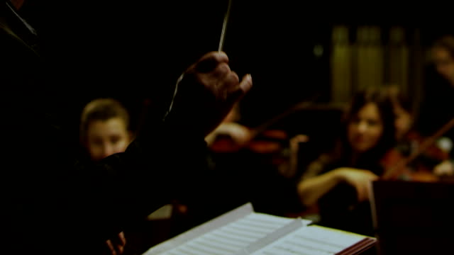 A conductor is conducting with a baton