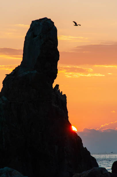 istock Human-like rock, sunrise and birds 1163484859