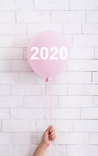 istock Pink balloon with text concept in woman hand on white 1163489320