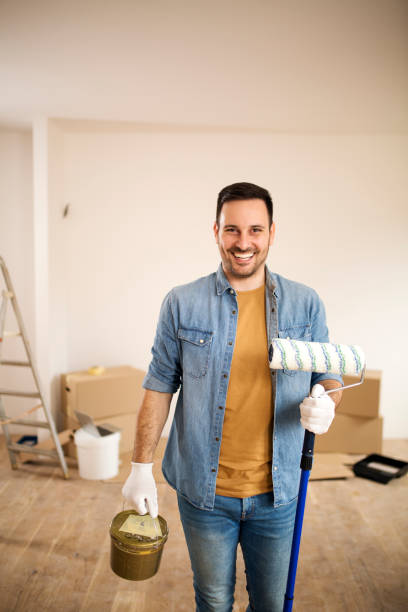 istock Man holding painting tools. 1163489927