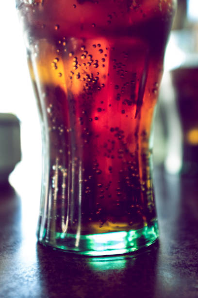 istock Backlit coke drink on a drinkng glass with bubbles 1163490038