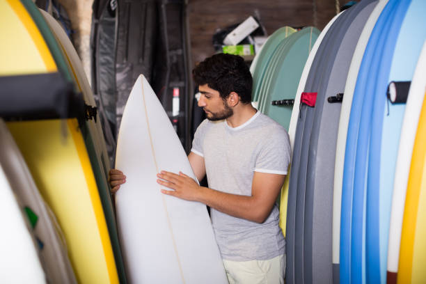 istock male with board for surfing 1163491123