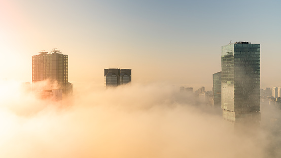 istanbul, Turkey - February 2019: Skyscrapers in Levent district under mist with sunshine
