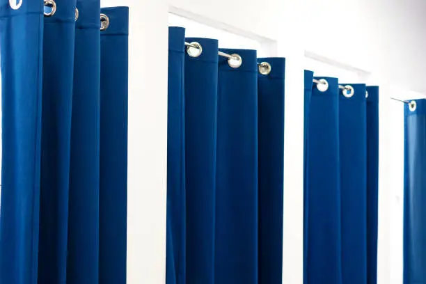 fitting rooms with blue curtains in the store
