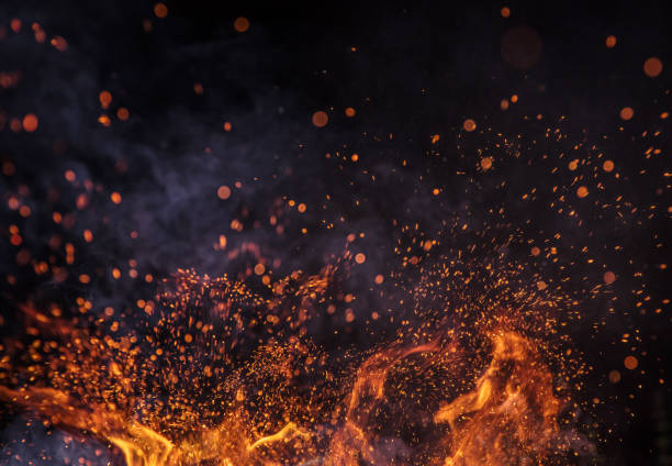 Burning sparks flying. Beautiful flames background. Burning sparks flying. Beautiful flames. Fiery orange glowing flying away particles on black background. flame sparks stock pictures, royalty-free photos & images