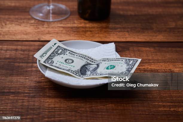Restaurant Tips Or Gratuity Banknotes And Coins On A Plate Stock Photo - Download Image Now