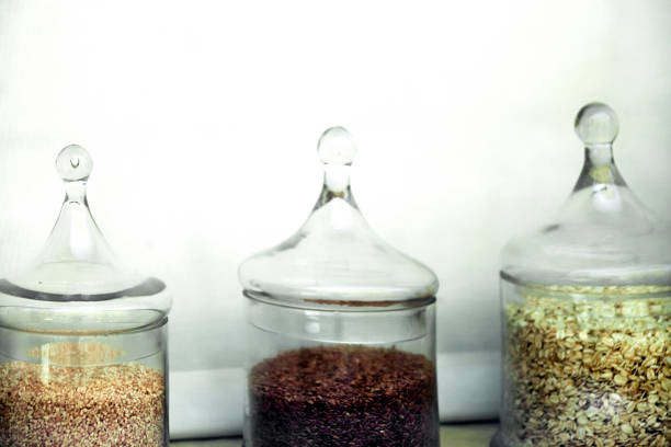 istock Transparent glass jars display with oat, seeds, nuts. 1163497519