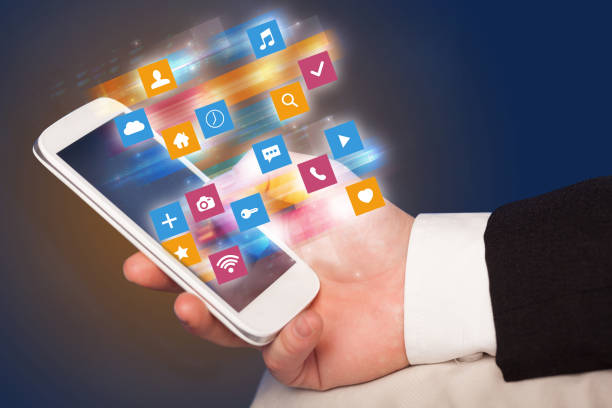 istock Hand using phone with colorful application icons and symbols concept 1163498789