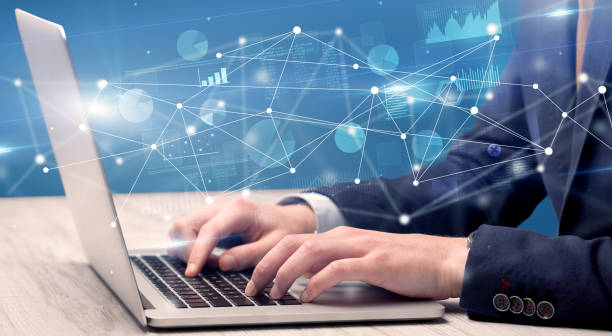 istock Hand typing on laptop with linked report and charts around 1163498875