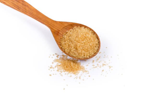istock Brown sugar in wooden spoon and beside on white background 1163499092